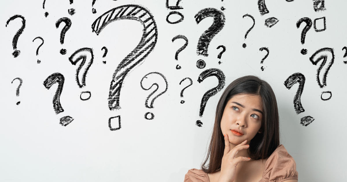 A woman thinking surrounded by question marks